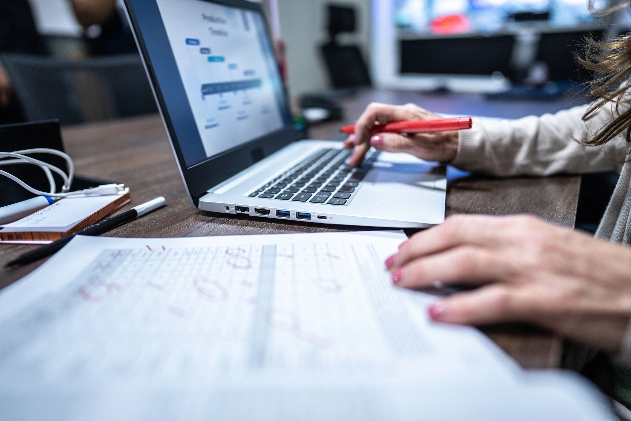Close-up of hands working on a laptop during document review